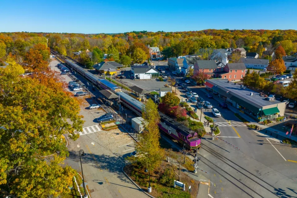 Aerial view of MBTA commuter rail station in Concord, Massachusetts among green trees